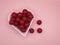 cherry flavored candies in a heart shaped ceramic bowl