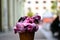 Cherry flavour ice cream scoop in waffle cone in closeup