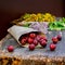 Cherry and flowers on a wooden craft table after rain