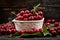 Cherry. Fresh sweet cherries bowl with leaves on wooden desktop table