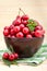 Cherry fruits in brown bowl