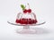 Cherry jelly on a glass stand for dessert with whole cherries above on white background