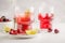 Cherry juice with ice and lime in a glass beaker, light background. White background.