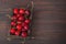 Cherry with leaf on plate and water dropsand on brown stone table