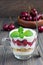 Cherry, muesli and yogurt dessert in glass cup, cherry verrine
