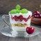 Cherry, muesli and yogurt dessert in glass cup, cherry verrine, square format