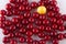 Cherry pattern. Variety of red fruits and one yellow on white background. Top view, flay lay