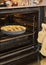 Cherry pie is baked in an electric oven in home kitchen