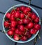 Cherry on the plate on the wood background