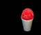 Cherry red Hawaiian Shave ice dessert on a black background.
