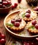 Cherry Tarts with vanilla custard and caramel, delicious dessert on a wooden table