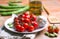 Cherry tomato, broad beans and garlic in white plate -