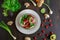 Cherry tomato salad, with mushrooms, onion on a black table, with some patterns