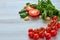 Cherry tomatoes, basil and garlic on the gray table. Cooking concept. Raw ingredients for salad, diet gazpacho soup, smoothie