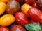 Cherry tomatoes and basil leaves in a spray of water on a wooden background. Selective focus. Local products consumption concept.