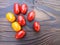 Cherry tomatoes and basil leaves on a wooden background. Selective focus. Local products consumption concept. Healthy eating.