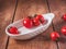 Cherry tomatoes with leaves on a porcelain white grater table