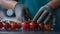 Cherry tomatoes packing process unknown worker cutting green parts closeup