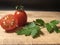 Cherry tomatoes and parsley on the wooden cutter board background