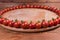 Cherry tomatoes on perimeter of wooden serving board close-up