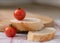 Cherry tomatoes on sliced fresh french bread, on kitchen towel