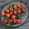 Cherry Tomatoes on Vine with Herbs Top View on Slate