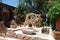 Chersonissos, Cyprus, Greece - 31.07.2013: The composition of the stone oven, stones and green plants under the burning sun on the