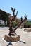 Chersonissos, Cyprus, Greece - 31.07.2013: sculpture of wood in the middle of the garden of plants and flowers in Crete