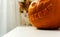 The Cheshire Cat shape carved pumpkin with out of focus red cat