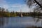 The Chesma column, located in the Big lake of the Catherine Park, is surrounded by trees. Against the blue sky