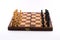 Chess board with black and white figurines on a white background