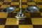 A chess-board and bronze scales as a background