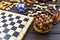 Chess board and chess figures, wooden cubes, puzzle games on dark wooden table. Popular logic  games for logical thinking