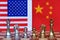 Chess board game pieces on USA and China flag background, trade war tension situation concept