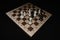 Chess board under black pawns for strategy theme