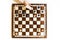 Chess board on white background. Little caucasian girl holding a black castle in the hand. Top view.