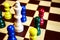Chess concept to diversification, colorful little pawns huddle around the big white old king