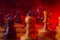 Chess fight, chess pieces on the board, toned in red. Battle fire and smoke