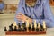 chess figures on wooden board. Focused school teacher. thinking of attacking and capturing opponent chess pieces