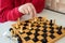 A chess game, a close up of a mans hand and chess