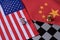 Chess game, two knights face to face on China and US national flags. Trade war concept. Conflict between two big countries, USA