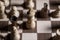 Chess game. White and black pieces are fighting for victory. The Central figure is in focus.