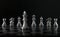 Chess King in front of chess figures in row on black background. Leader, leadership, business strategy, success, victory, win,