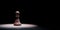 Chess Pawn Spotlighted on Black Background