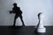 Chess pawn standing in a spotlight that make a shadow of soldier