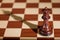 Chess piece - a black queen on a chessboard.