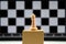 Chess piece - queen on podium against background of chess board. concept of leadership, victory