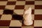 Chess piece - a white knight on a chessboard.