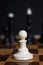 Chess piece white pawn on a chessboard. Chess game. Pawn against all