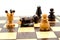 Chess pieces on chess-board with fallen king